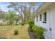 Side exterior view of a white-brick home with manicured landscaping and mature trees at 2694 Benjamin E Mays Sw Dr, Atlanta, GA 30311