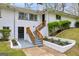 Side angle view of a stylish white-brick home with charming landscaping and wooden stair railing at 2694 Benjamin E Mays Sw Dr, Atlanta, GA 30311