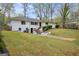 A spacious backyard with a well-maintained lawn surrounds a white-brick home with black trim at 2694 Benjamin E Mays Sw Dr, Atlanta, GA 30311