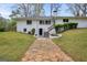 Inviting white-brick home features a landscaped lawn and unique hexagonal paver walkway at 2694 Benjamin E Mays Sw Dr, Atlanta, GA 30311