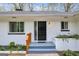 Inviting white brick home featuring a modern black front door with sidelight window and manicured landscaping at 2694 Benjamin E Mays Sw Dr, Atlanta, GA 30311