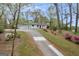 A wide driveway leads to a painted brick home with a well-manicured lawn and beautiful landscaping at 2694 Benjamin E Mays Sw Dr, Atlanta, GA 30311