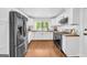 Bright kitchen features white cabinets, stainless steel appliances, and hardwood floors, creating a modern space at 2694 Benjamin E Mays Sw Dr, Atlanta, GA 30311