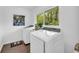 Bright laundry room with a window offering wooded views and featuring a newer model washer and dryer set at 2694 Benjamin E Mays Sw Dr, Atlanta, GA 30311