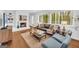Inviting living room with hardwood floors, a white brick fireplace, and abundant natural light at 2694 Benjamin E Mays Sw Dr, Atlanta, GA 30311