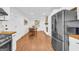 Open floor plan showcases the dining area, living room with brick fireplace, and stainless steel refrigerator at 2694 Benjamin E Mays Sw Dr, Atlanta, GA 30311