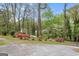 View of the property as seen from the street with mature trees and azalea bushes lining the front at 2694 Benjamin E Mays Sw Dr, Atlanta, GA 30311