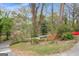 Roadside view of lush trees and landscaping around the home's front yard at 2694 Benjamin E Mays Sw Dr, Atlanta, GA 30311