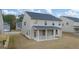 New home with a well-maintained backyard, covered patio, and lush green lawn at 675 Edgar St, Hampton, GA 30228