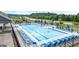 Community pool with blue lounge chairs, umbrellas, and well maintained landscaping at 675 Edgar St, Hampton, GA 30228