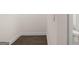 Hallway with wood flooring and view of an adjacent half bath at 675 Edgar St, Hampton, GA 30228