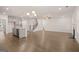 Spacious open-concept living area with stainless steel appliances and hardwood floors at 675 Edgar St, Hampton, GA 30228