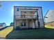 A well-maintained backyard featuring a covered deck and access to the basement at 1704 Goodwin Dr, Hampton, GA 30228