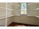 Walk-in pantry featuring custom shelving for organized storage, complemented by a window for natural light at 4585 Parkwood Rd, Social Circle, GA 30025