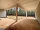 This covered patio offers seamless outdoor living, opening to a verdant lawn with natural light and wooded views at 4585 Parkwood Rd, Social Circle, GA 30025