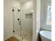 Modern bathroom with walk-in shower, floating tub, neutral tile, and stylish black fixtures at 4601 Parkwood Rd, Social Circle, GA 30025