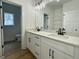 Double sink bathroom vanity with a framed mirror and black faucets at 4601 Parkwood Rd, Social Circle, GA 30025