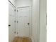 Hallway with white paneled doors and black door hardware at 4601 Parkwood Rd, Social Circle, GA 30025
