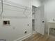 Bright laundry room features shelving, utility sink, and washer/dryer hookups at 4601 Parkwood Rd, Social Circle, GA 30025