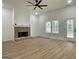 Spacious living room with wood flooring, a brick fireplace, and a view to the outdoors at 4601 Parkwood Rd, Social Circle, GA 30025
