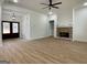 Bright living room with wood flooring features a brick fireplace and double front doors at 4601 Parkwood Rd, Social Circle, GA 30025