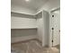 Bright walk-in closet with ample storage features custom shelving at 4601 Parkwood Rd, Social Circle, GA 30025