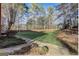 Large, grassy backyard bordered by mature trees and a wooden fence, perfect for outdoor activities at 1090 Crown River Pkwy, Mcdonough, GA 30252