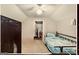 Cozy carpeted bedroom with a bed, chalkboard and ceiling fan at 1090 Crown River Pkwy, Mcdonough, GA 30252
