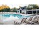 Inviting community pool with lounge chairs, landscaping, and a nearby building for residents at 1090 Crown River Pkwy, Mcdonough, GA 30252
