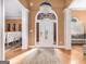 Grand foyer with hardwood floors, a decorative chandelier, and views to the dining room at 1090 Crown River Pkwy, Mcdonough, GA 30252