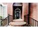 Inviting front porch with arched entry and brick steps at 1090 Crown River Pkwy, Mcdonough, GA 30252