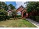 Charming red brick home with arched windows and mature landscaping at 1090 Crown River Pkwy, Mcdonough, GA 30252