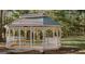 Picturesque white gazebo nestled among the trees with seating and a traditional roof at 1090 Crown River Pkwy, Mcdonough, GA 30252
