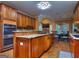 Expansive kitchen with island cooktop, stainless appliances, and eat in dining area at 1090 Crown River Pkwy, Mcdonough, GA 30252