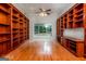 Spacious living room featuring hardwood floors and custom built-in bookshelves surrounding a beautiful window at 1090 Crown River Pkwy, Mcdonough, GA 30252