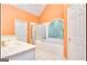 Main bathroom with a bathtub, gold fixtures, shower, white tile and vaulted ceilings at 1090 Crown River Pkwy, Mcdonough, GA 30252