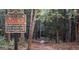Nature walk entrance with signage about rules and a trail leading into a wooded area at 1090 Crown River Pkwy, Mcdonough, GA 30252