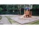 Community playground area featuring play structures, a slide, and a basketball court in the background at 1090 Crown River Pkwy, Mcdonough, GA 30252