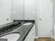 Bathroom featuring dual sinks, granite countertops, and modern fixtures at 100 Hugh Dr, Covington, GA 30016