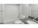 Bathroom with a shower-tub combo and a granite countertop sink at 100 Hugh Dr, Covington, GA 30016