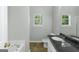 Bathroom featuring a bathtub, shower, toilet and vanity with granite countertop at 100 Hugh Dr, Covington, GA 30016