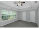 Bright primary bedroom with recessed ceilings, multiple closets, and a large window at 100 Hugh Dr, Covington, GA 30016