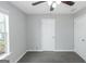 Bedroom featuring neutral paint, gray carpet, ceiling fan and window at 100 Hugh Dr, Covington, GA 30016