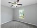 Bedroom with gray carpet, ceiling fan and a window view to the outside at 100 Hugh Dr, Covington, GA 30016