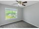 Bedroom with neutral carpet, a ceiling fan, and a large window with natural light at 100 Hugh Dr, Covington, GA 30016