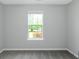 Neutral bedroom with a window letting in natural light and a view of the outdoors at 100 Hugh Dr, Covington, GA 30016