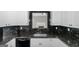 Bright kitchen offering white cabinetry, modern appliances and stainless steel sink at 100 Hugh Dr, Covington, GA 30016