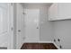 Functional laundry room with white cabinets, a door, and washer/dryer hookups at 100 Hugh Dr, Covington, GA 30016