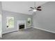 Inviting living room with bright windows, neutral carpeting, and cozy fireplace at 100 Hugh Dr, Covington, GA 30016