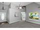 Bright living room featuring vaulted ceilings, a ceiling fan and neutral carpeting at 100 Hugh Dr, Covington, GA 30016
